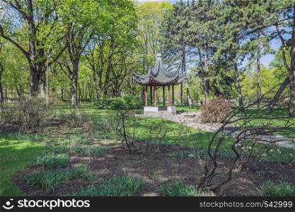 City Riga, Latvia Republic. City park with china gazebo. Trees and nature. May 7. 2019 Travel photo.
