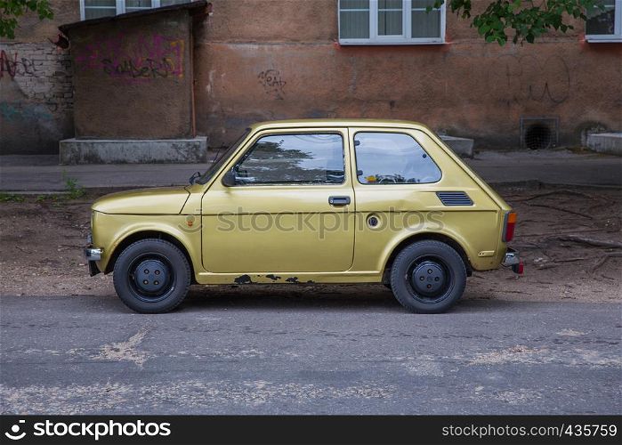 City Riga, Latvia. Retro Fiat 126 at street, gold color. Urban city view. 2018.