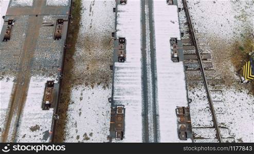 City Riga, Latvia. The locomotive pulls an empty cargo platform, visible rails and snow. 16.01.2020
