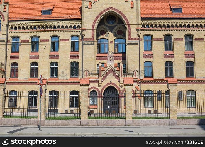 City Riga, Latvian Republic. An old building with interesting ornaments and yellow bricks. 2019. 24. July.
