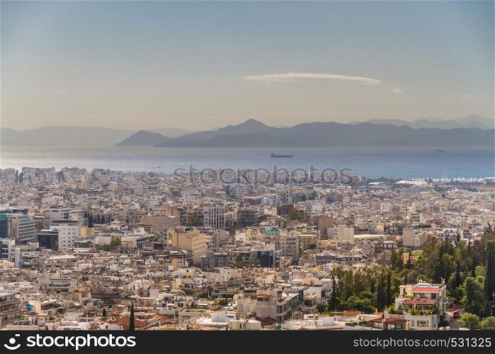 City scape of Athens in Greece, Mediterranean in the background.