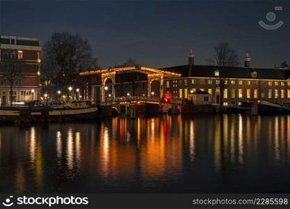 City scenic from Amsterdam at the Amstel in the Netherlands at night