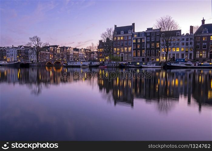 City scenic from Amsterdam at the Amstel in the Netherlands at sunset