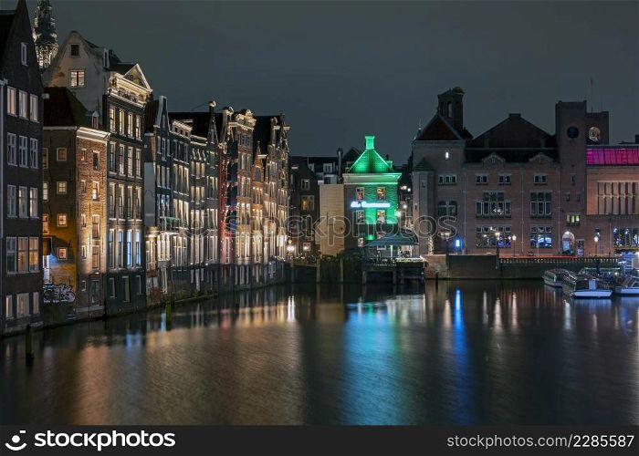 City scenic from Amsterdam at the Damrak in the Netherlands at night