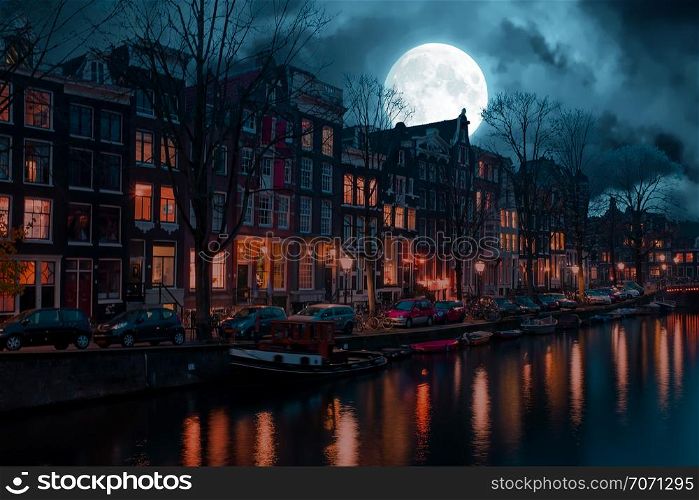 City scenic from Amsterdam in the Netherlands by night at full moon
