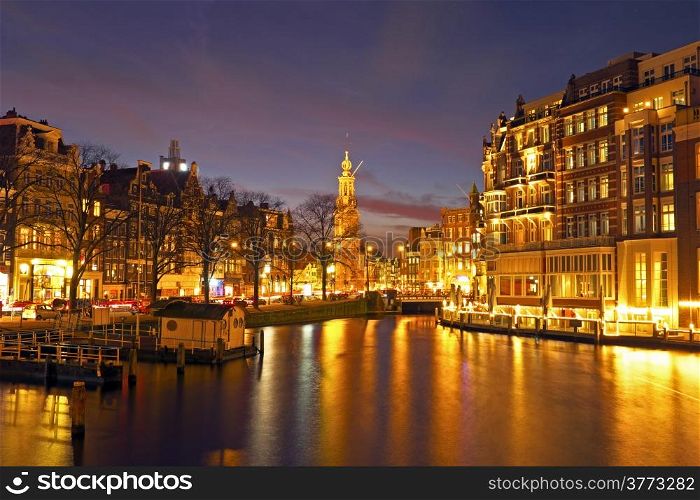 City scenic from Amsterdam in the Netherlands by night with the Munttower