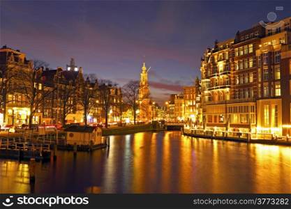 City scenic from Amsterdam in the Netherlands by night with the Munttower