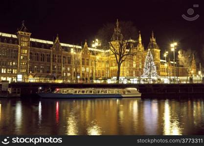 City scenic from Amsterdam in the Netherlands with the central station at night