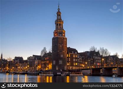 City scenic from Amsterdam with the Montelbaan Tower in the Netherlands at sunset