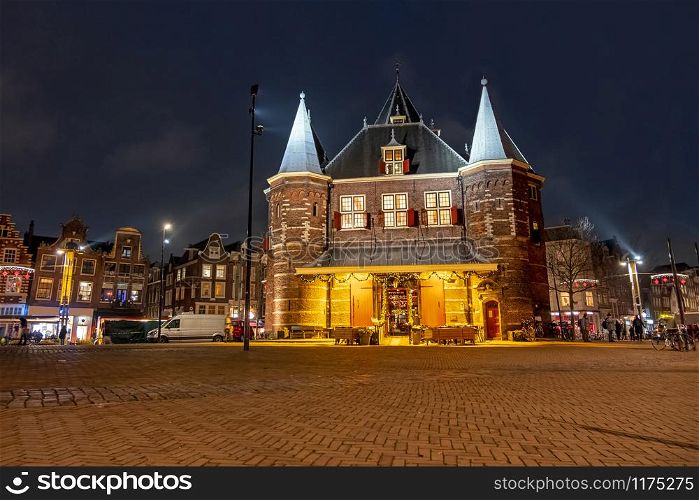 City scenic from Amsterdam with the Waag building on the Nieuwmarkt in the Netherlands at night