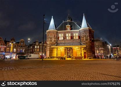 City scenic from Amsterdam with the Waag building on the Nieuwmarkt in the Netherlands at night