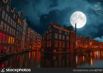 City scenic in Amsterdam the Netherlands at night by full moon