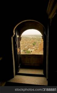 City seen through a window, Rajmahal, Jaisalmer, Rajasthan, India