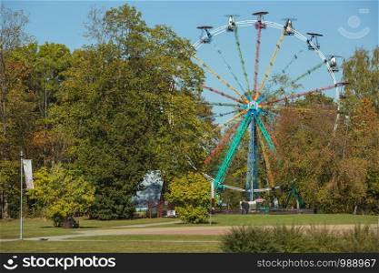 City Sigulda, Latvia Republic. Ferris wheel and trees with yellow leafs. 27. Sep. 2019