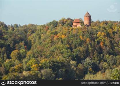 City Sigulda, Latvia Republic. Old castle, build from red bricks. Around trees with yellow leafs. 27. Sep. 2019