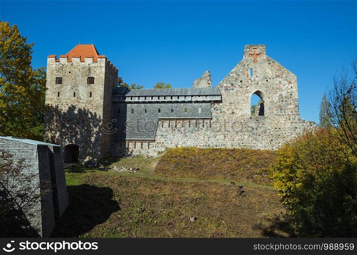 City Sigulda, Latvia Republic. Old castle from build rocks and tree with yellow leafs. 27. Sep. 2019
