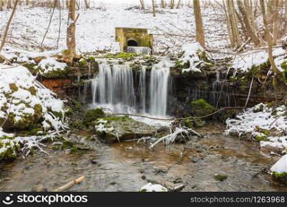 City Sigulda, Latvia. Waterfall in winter. White snow and trees. Travel photo.29.02.2020