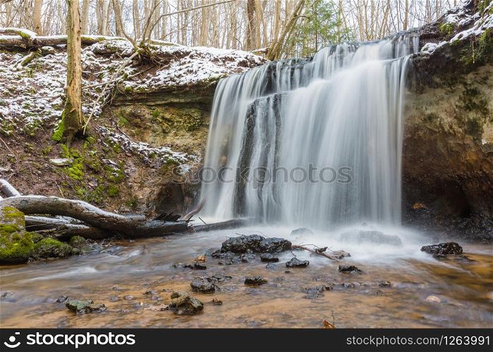 City Sigulda, Latvia. Waterfall in winter. White snow and trees. Travel photo.29.02.2020