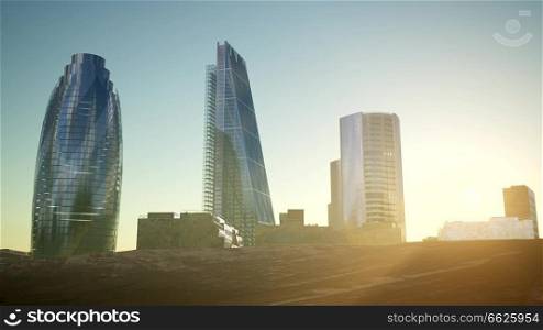 city skyscrapes in desert at sunset