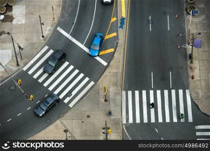 City street with crosswalks on asphalt road and car traffic. Fast city life transportation concept.