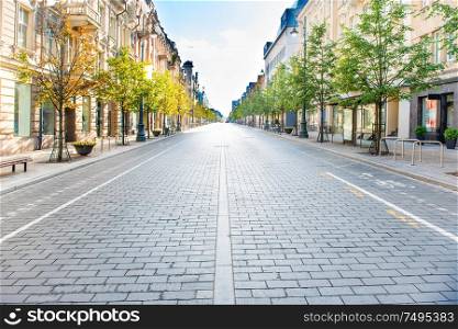 City street with empty road and morning light in Europe, Lithuania, Vilnius