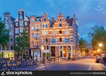 City street with glowing lights early in the morning. Amsterdam. Netherlands.. Amsterdam. City street early in the morning.