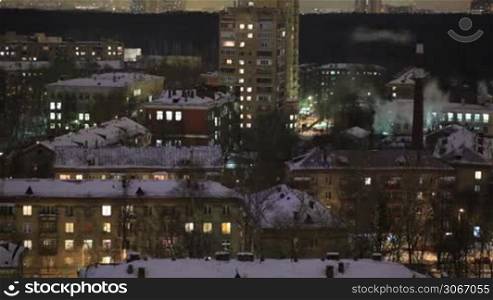 City time lapse at night. Factory chimney with smoke. Moscow, aerial view. Wide shot, high angle.