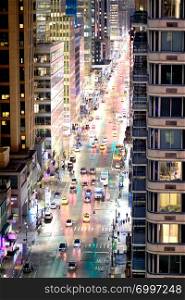 City traffic at night, aerial view of main avenue, New York City.