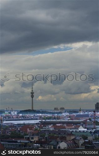 City view, featuring Olympic Park Tower with stormy sky. Munich, Bavaria, Germany, Europe. Space at top of image.