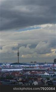 City view, featuring Olympic Park Tower with stormy sky. Munich, Bavaria, Germany, Europe. Space at top of image.