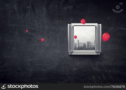 City view in window from inside of a room with black chalk board wall. City view in window from inside of a room