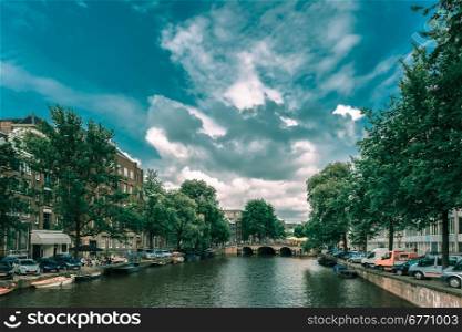 City view of Amsterdam canal and bridge, Holland, Netherlands.. Toning in cool tones
