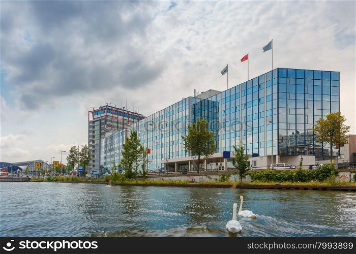 City view of Amsterdam canal and modern building, Holland, Netherlands.