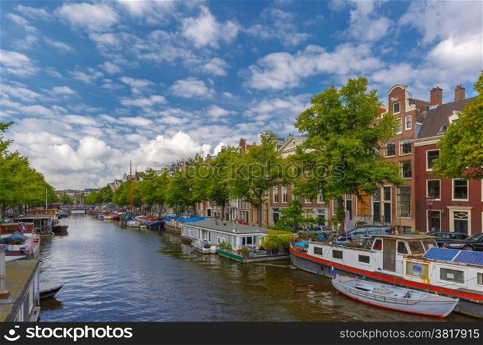 City view of Amsterdam canals and typical houseboats and boats, Holland, Netherlands.