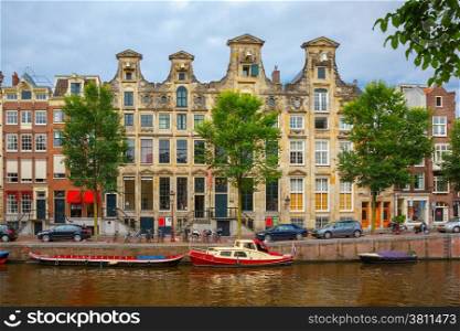 City view of Amsterdam canals and typical houses, boats and bicycles, Holland, Netherlands.