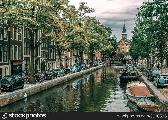 City view of Amsterdam canals and typical houses, boats and bicycles, Holland, Netherlands... Toning in cool tones