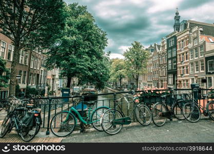 City view of Amsterdam canals and typical houses, boats and bicycles, Holland, Netherlands... Toning in cool tones