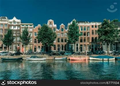 City view of Amsterdam canals and typical houses, boats and bicycles, Holland, Netherlands.. Toning in cool tones