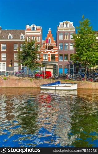 City view of Amsterdam canals and typical houses, boats and bicycles, Holland, Netherlands.