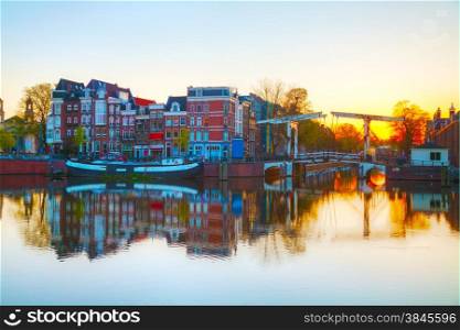City view of Amsterdam, the Netherlands at sunrise with Amstel river