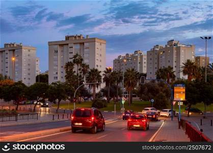Cityscape and car traffic at sunset, street lights, Sant Joan, Alicante, Spain