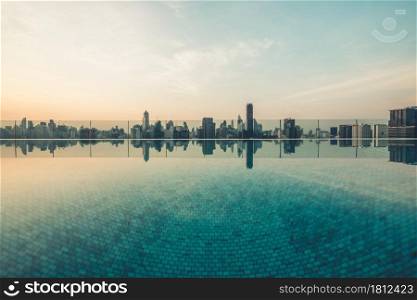 Cityscape and high-rise buildings in metropolis city with water reflection in the early morning .. Cityscape and high-rise buildings in metropolis city with water reflection
