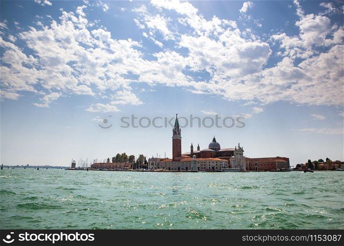 Cityscape from water on historical party of Venice Italy with view of San Giorgio Maggiore in a sunny summer day.. Panoramic view from water to San Giorgio Maggiore, Venice Italy.