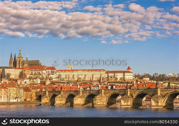 Cityscape in Prague, the capital of Czech Republic, with Charles Bridge under a blue sky with white clouds.