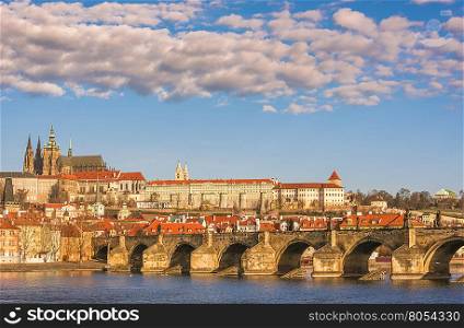 Cityscape in Prague, the capital of Czech Republic, with Charles Bridge under a blue sky with white clouds.