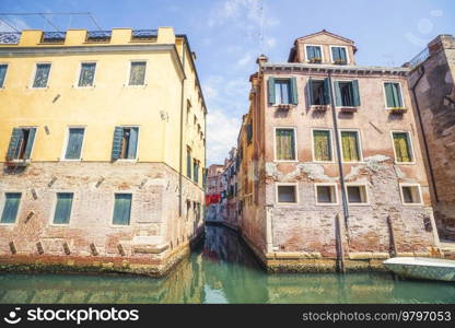 Cityscape in Venice Italy with a river canal going by the old houses in the summertime