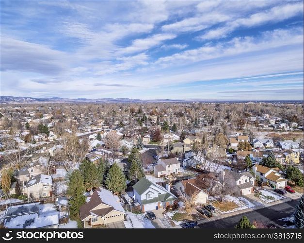 cityscape of a typical residential area along Colorado Front Range - aerial view of Fort Collin from a low flying drone, foothills of Rocky Mountains in background