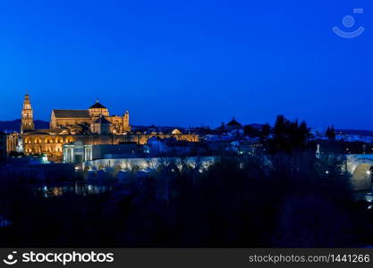 Cityscape of Cordoba at sunset with roman bridge and Mezquita, Andalusia, Spain. Mezquita and roman bridge