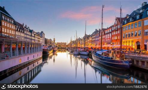 Cityscape of downtown Copenhagen city skyline in Denmark at famous old Nyhavn port at sunset