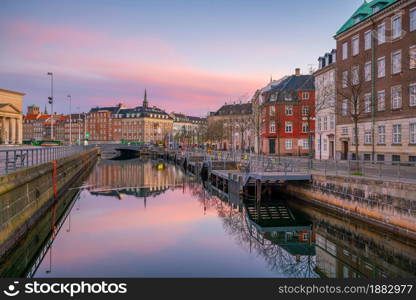 Cityscape of downtown Copenhagen city skyline in Denmark at sunset